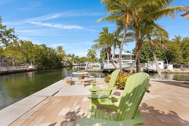 view of dock featuring a patio area and a water view