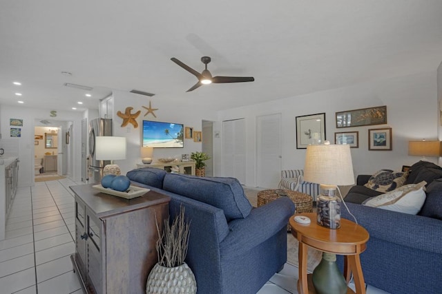 living room featuring light tile patterned flooring and ceiling fan