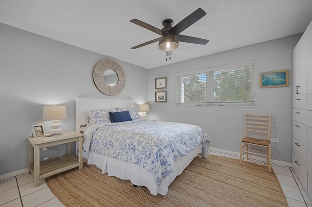 tiled bedroom featuring ceiling fan