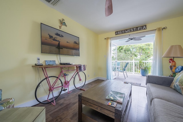 living room with visible vents, baseboards, wood finished floors, and a ceiling fan