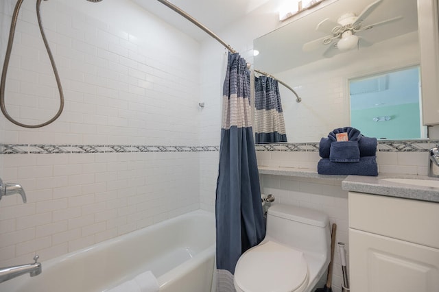 full bathroom with tile walls, toilet, shower / tub combo with curtain, vanity, and a ceiling fan