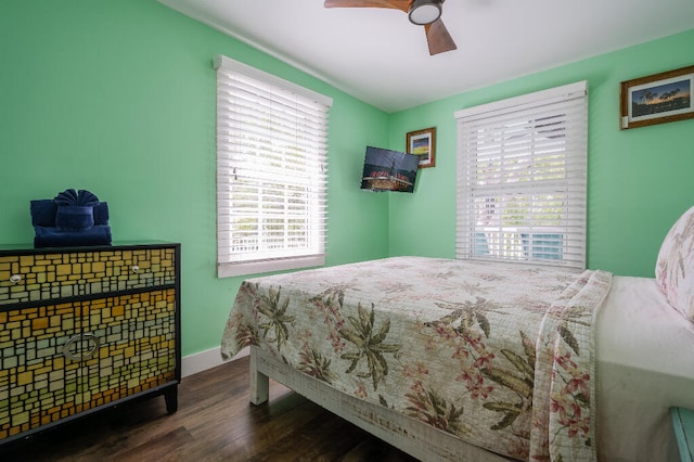 bedroom featuring ceiling fan, baseboards, and wood finished floors