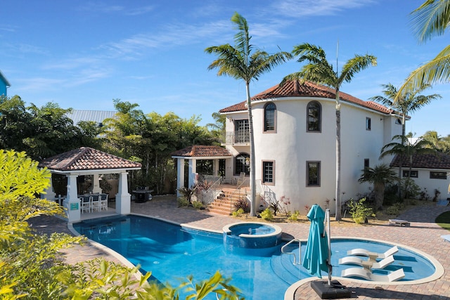 view of swimming pool with a gazebo, an in ground hot tub, and a patio