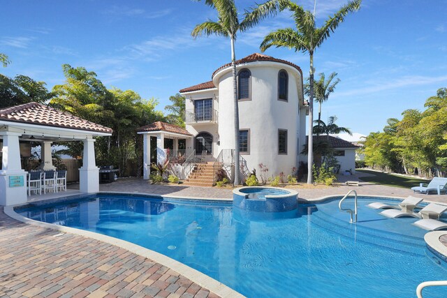 view of pool featuring a gazebo, a patio area, and an in ground hot tub