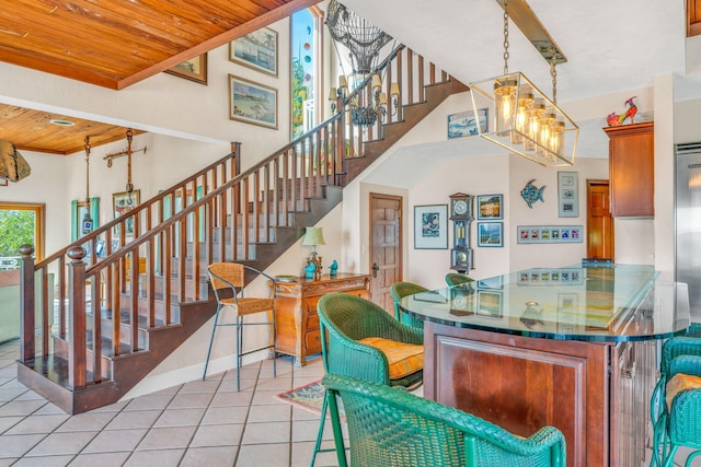 4500 Filer Cove Rd, Big Torch, FL 33042 - bar area with tile patterned floors, stairway, wooden ceiling, a chandelier, and baseboards
