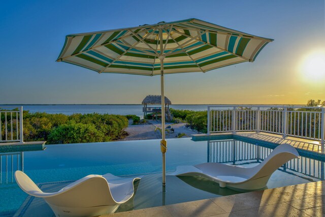 4500 Filer Cove Rd, Big Torch, FL 33042 - pool at dusk featuring a water view and a water slide