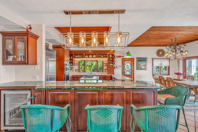 4500 Filer Cove Rd, Big Torch, FL 33042 - kitchen with wine cooler, a chandelier, stainless steel appliances, glass insert cabinets, and pendant lighting