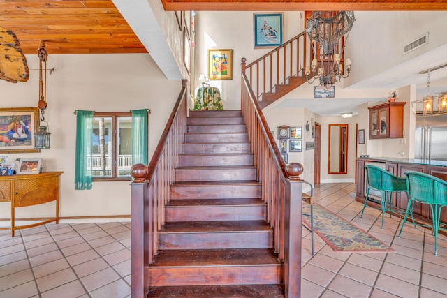 4500 Filer Cove Rd, Big Torch, FL 33042 - staircase featuring tile patterned floors, a towering ceiling, a chandelier, and baseboards