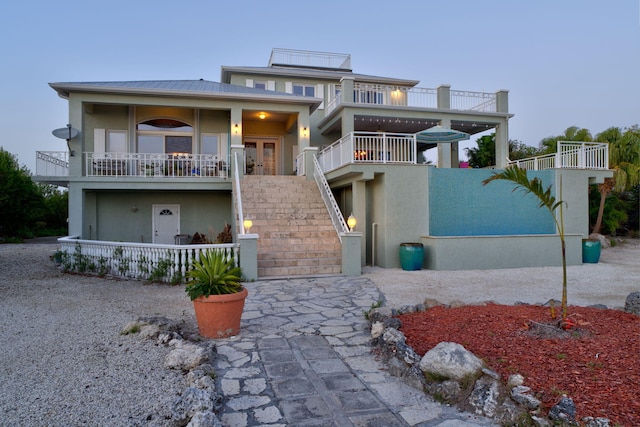4500 Filer Cove Rd, Big Torch, FL 33042 - view of front of home with stucco siding, stairs, french doors, metal roof, and a balcony