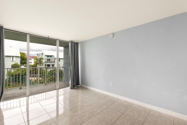 3312 Northside Dr Unit 305, Key West, FL 33040 - tiled empty room featuring baseboards, floor to ceiling windows, and a smoke detector