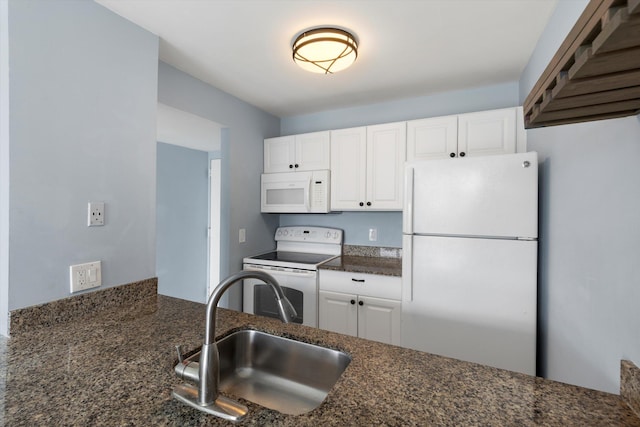 kitchen with white appliances, a sink, white cabinets, and dark stone counters