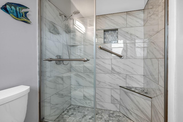 bathroom with an enclosed shower and toilet