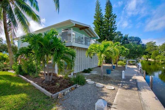 exterior space featuring a water view and a boat dock