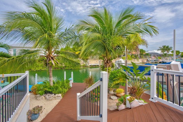 wooden terrace featuring a water view and a boat dock