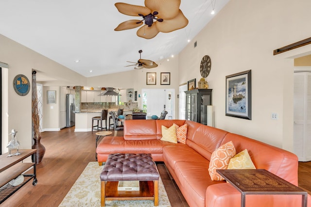 living room with high vaulted ceiling, dark hardwood / wood-style floors, and ceiling fan