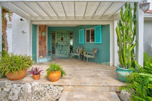 property entrance featuring a pergola