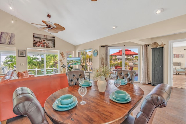 dining space with french doors, ceiling fan, lofted ceiling, and light wood-type flooring