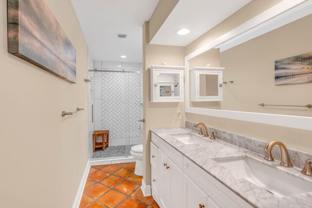 bathroom with vanity, tile patterned floors, toilet, and tiled shower