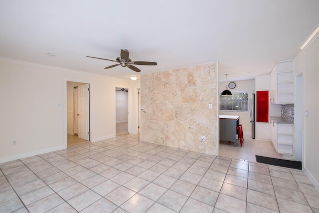 empty room featuring crown molding, light tile patterned floors, and ceiling fan