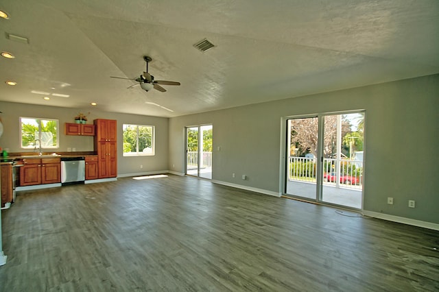 unfurnished living room featuring sink, hardwood / wood-style flooring, and ceiling fan