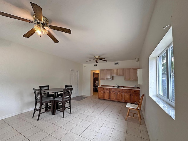 tiled dining room with sink and ceiling fan