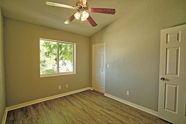 spare room featuring ceiling fan, lofted ceiling, and dark hardwood / wood-style flooring