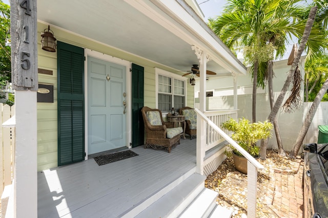 property entrance featuring covered porch and ceiling fan