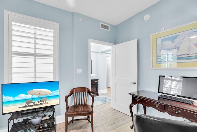 97501 Overseas Hwy Unit 113, Key Largo, FL 33037 - living area featuring light wood-style floors, baseboards, healthy amount of natural light, and a desk
