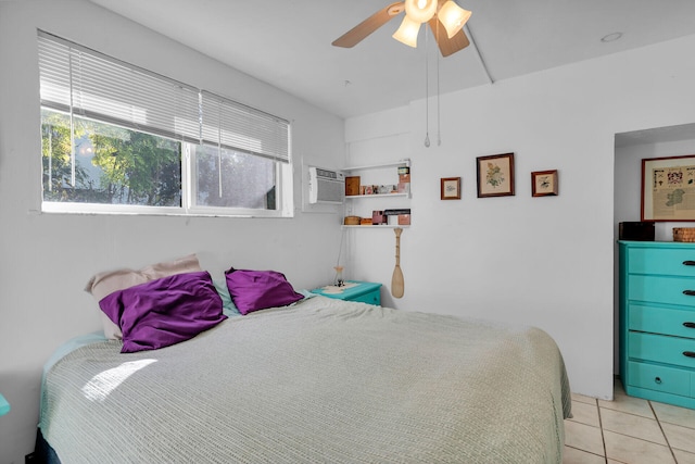 bedroom with a ceiling fan, an AC wall unit, and light tile patterned floors