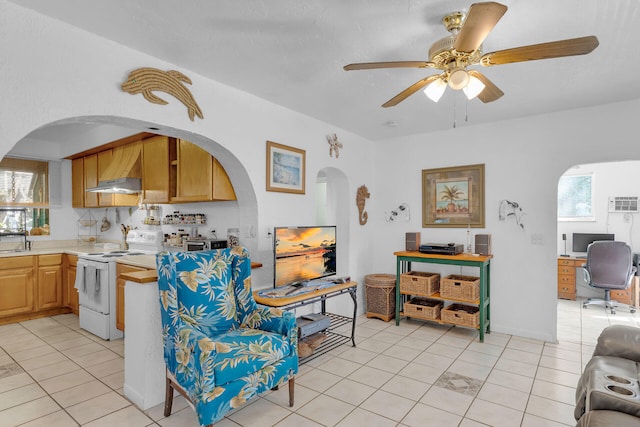 interior space featuring light tile patterned floors, ceiling fan, and a wealth of natural light