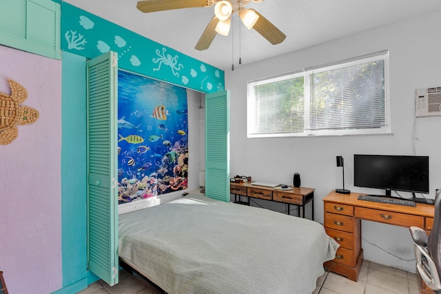 bedroom featuring light tile patterned floors, ceiling fan, and a wall mounted air conditioner