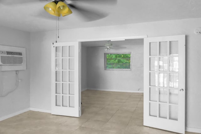 unfurnished room with ceiling fan, baseboards, and a wall mounted AC