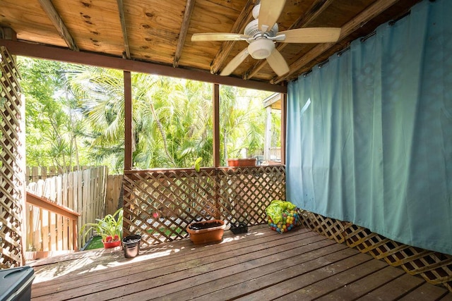 unfurnished sunroom with ceiling fan, wooden ceiling, and a wealth of natural light