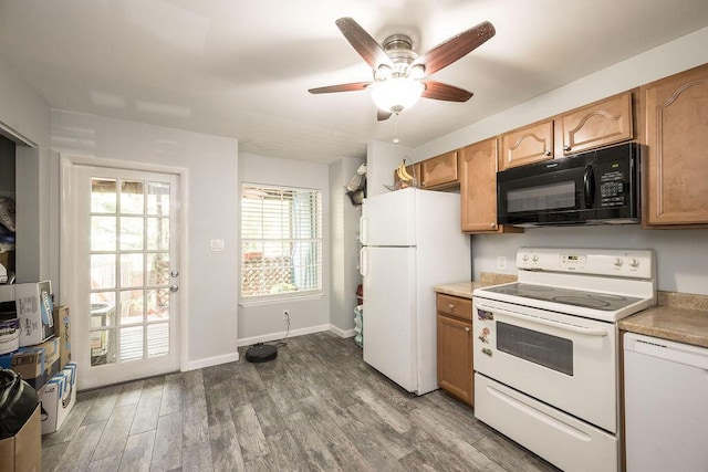 kitchen featuring ceiling fan, light countertops, white appliances, and wood finished floors