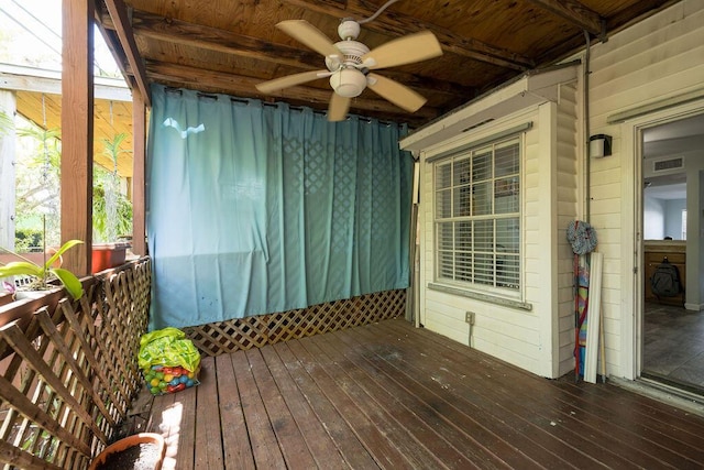 wooden terrace with visible vents and a ceiling fan