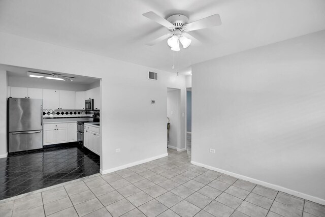 kitchen featuring tasteful backsplash, light tile patterned floors, ceiling fan, stainless steel appliances, and white cabinets