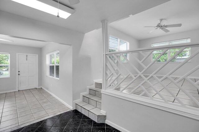 entryway featuring tile patterned flooring, a wealth of natural light, and ceiling fan