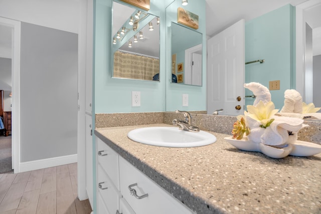 bathroom featuring vanity and wood-type flooring