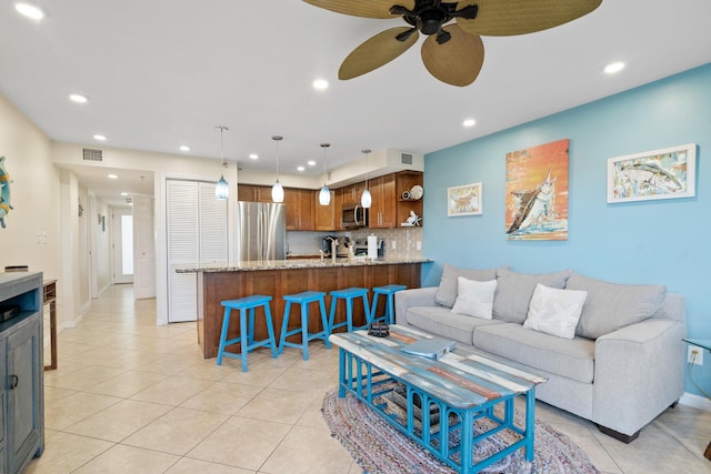 living area with light tile patterned flooring, visible vents, and recessed lighting