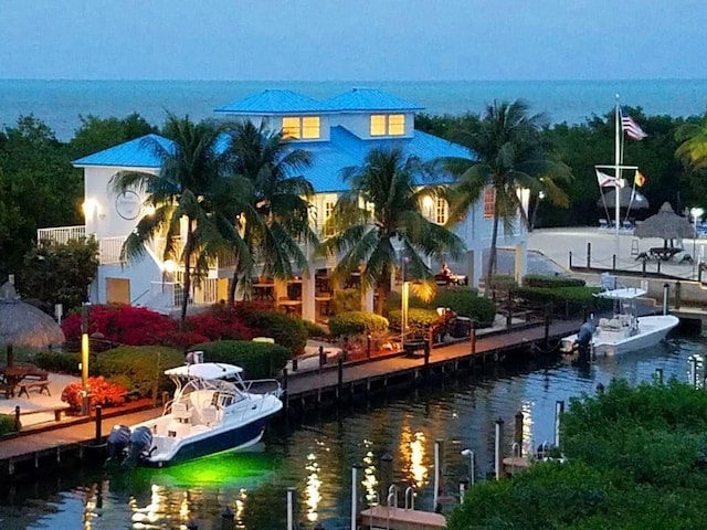 exterior space with a water view and a dock