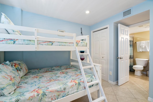 tiled bedroom featuring a closet