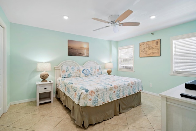 bedroom with ceiling fan and light tile patterned flooring