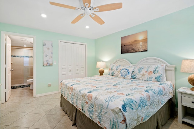 bedroom featuring connected bathroom, light tile patterned floors, a closet, and ceiling fan