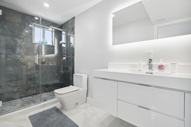 bathroom featuring vanity, a shower with shower door, and toilet