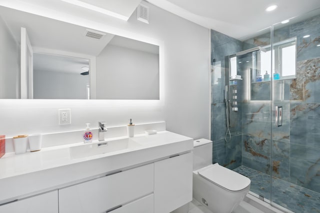 bathroom featuring vanity, an enclosed shower, and toilet