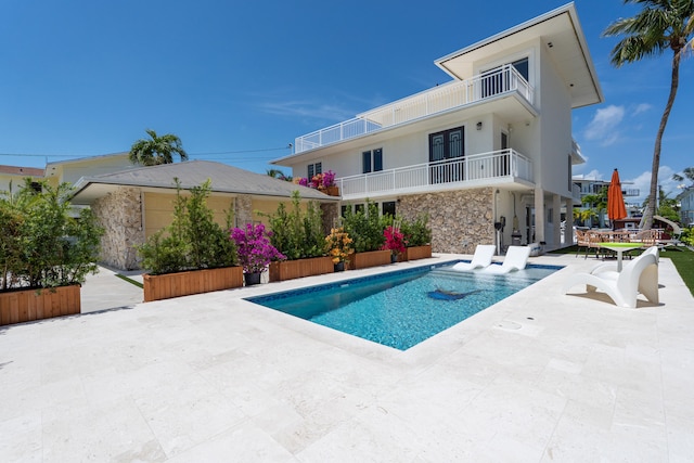 view of swimming pool with a patio