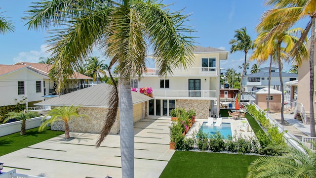 rear view of property with a balcony and a patio