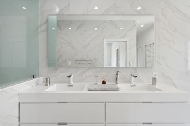 bathroom featuring vanity and tile walls