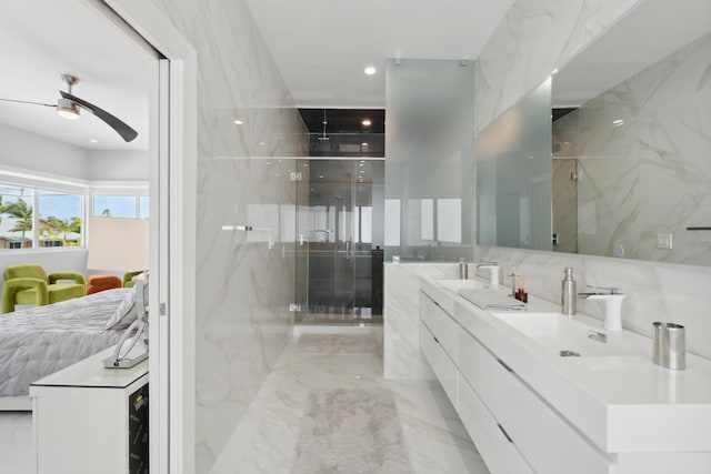 bathroom with ceiling fan, vanity, and a shower with door