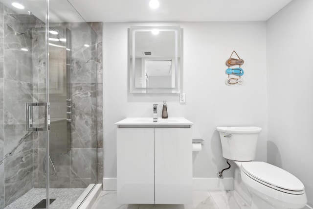 bathroom featuring vanity, a shower with shower door, and toilet